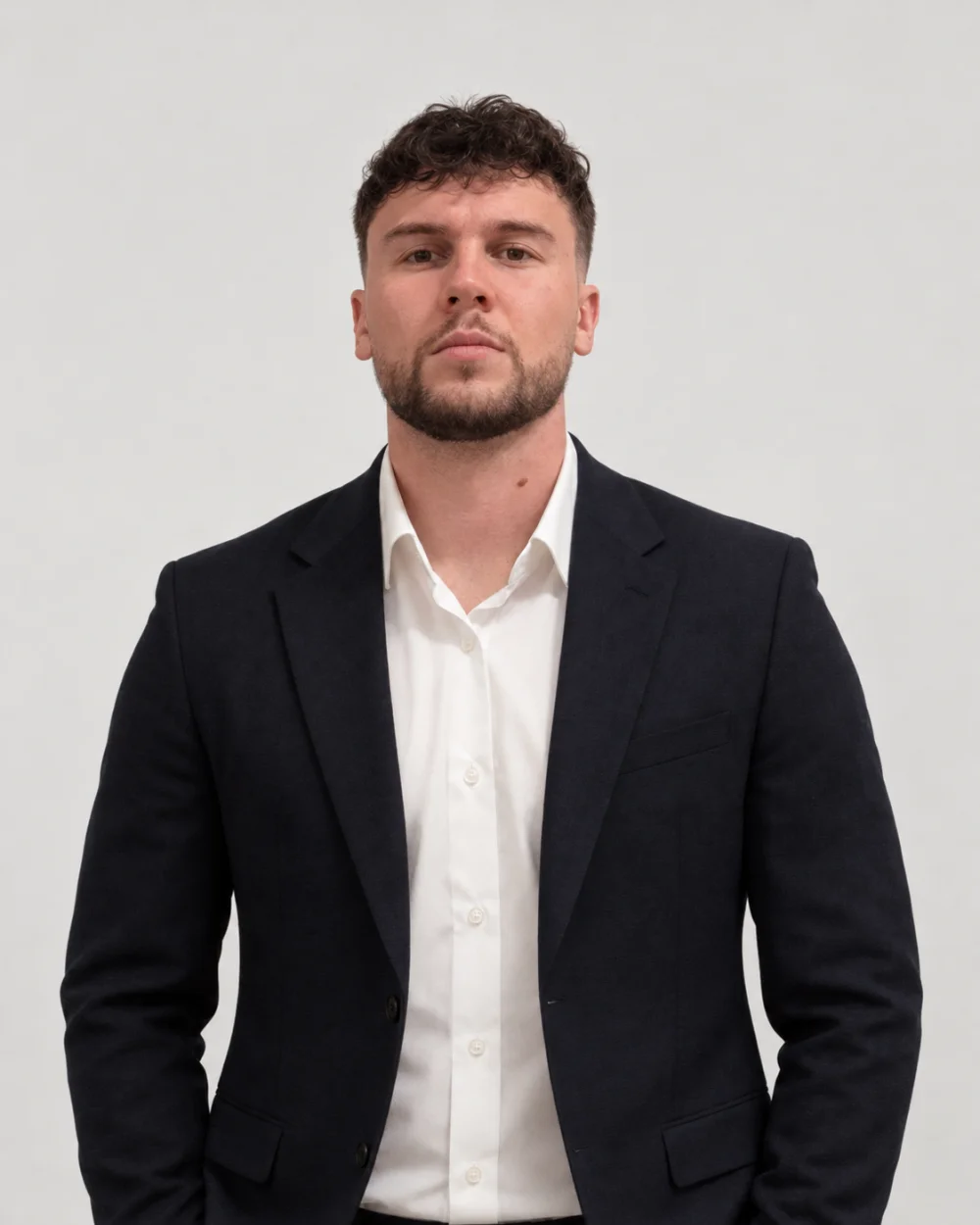 Zvonimir Rezo wearing a dark blazer and white shirt against a light background